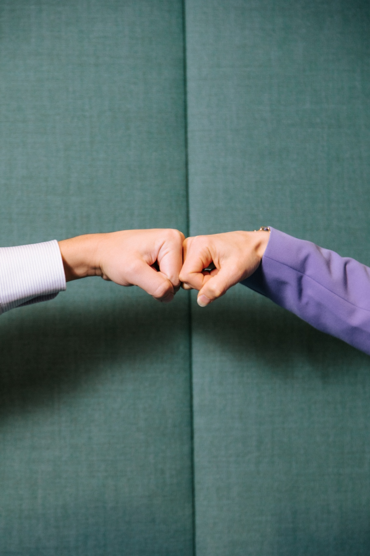 Twee handen bevestigen een afspraak met een fist bump